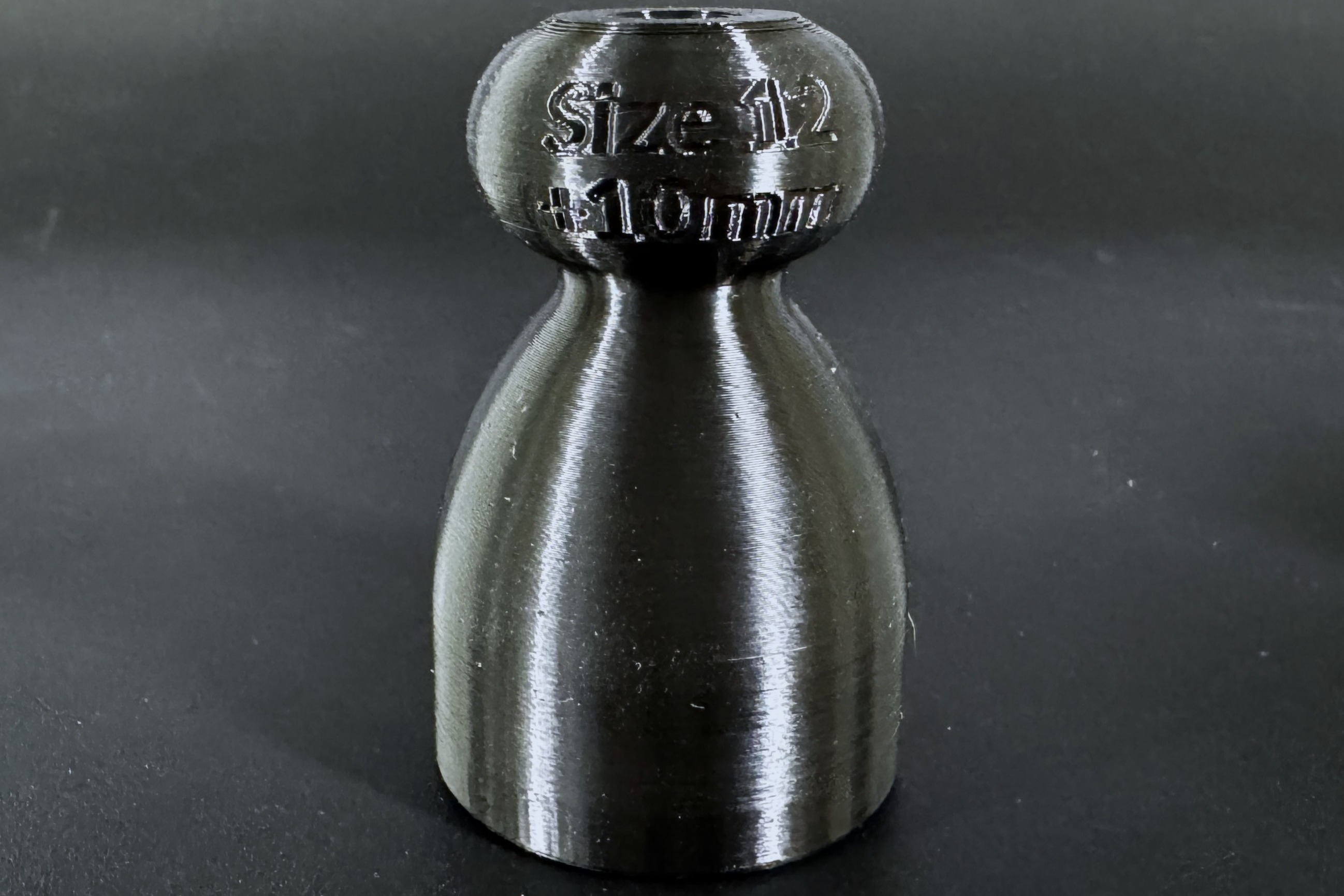 Close up of a demo P-tainer with its size and length embossed into the knob end.
