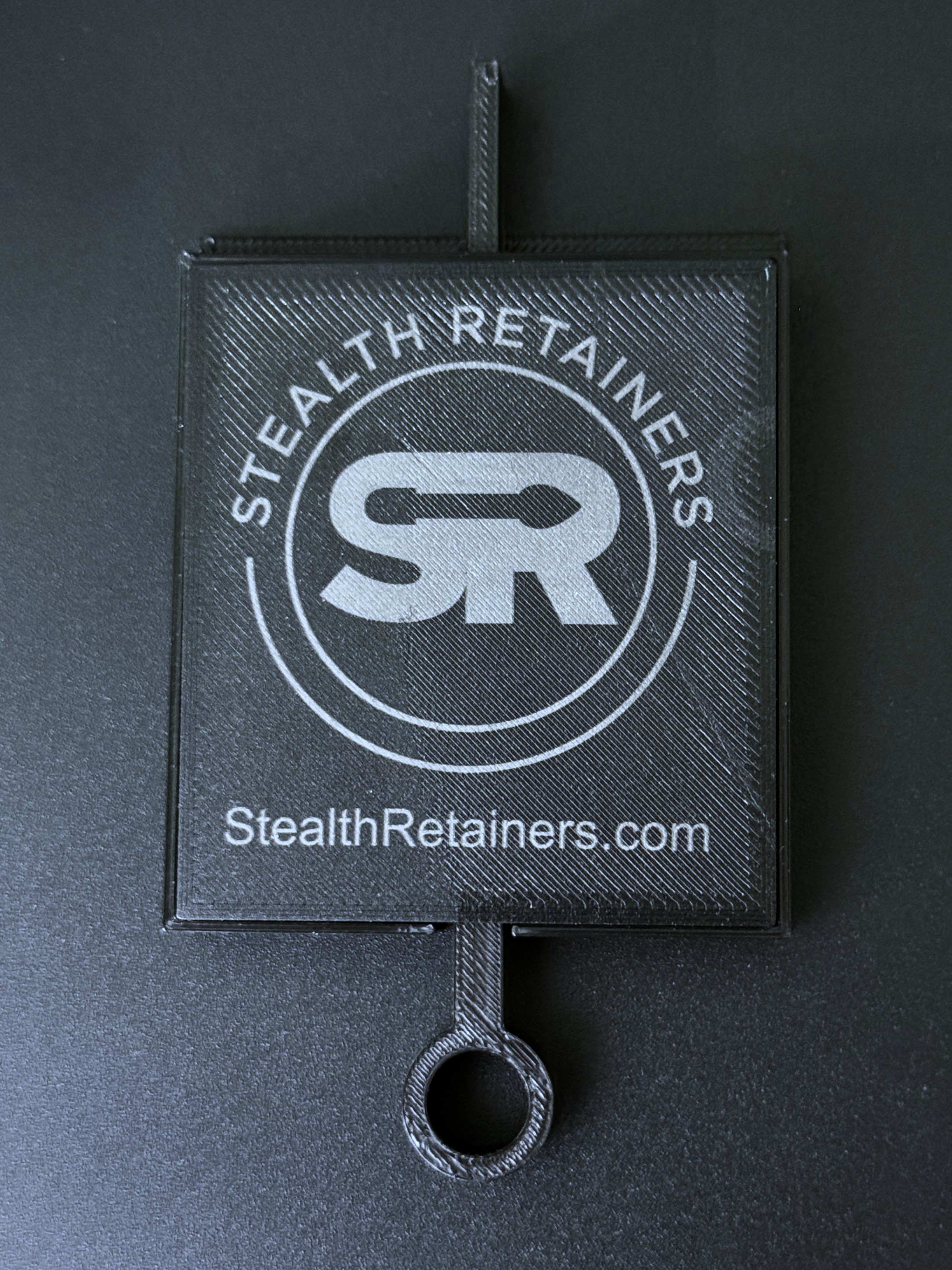 The back of the tension gauge, printed with the Stealth Retainers logo and StealthRetainers.com.