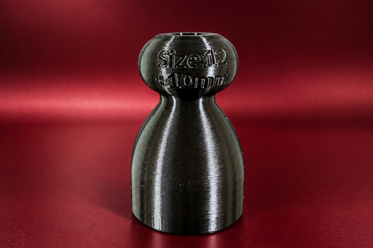 Close up of a demo P-tainer with its size and length printed on the knob end.
