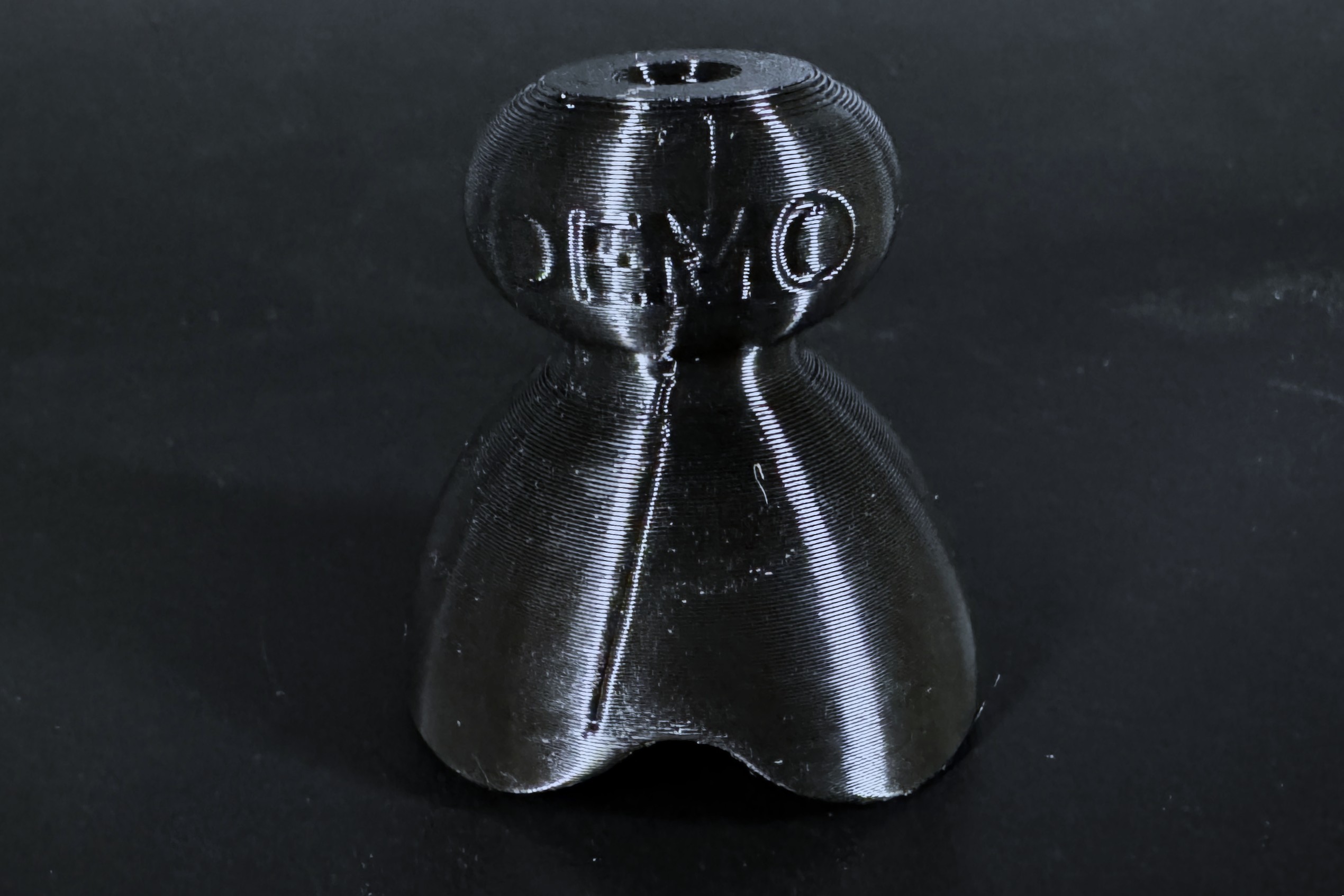Close up of a demo P-tainer showing the DEMO marking and visible print lines.