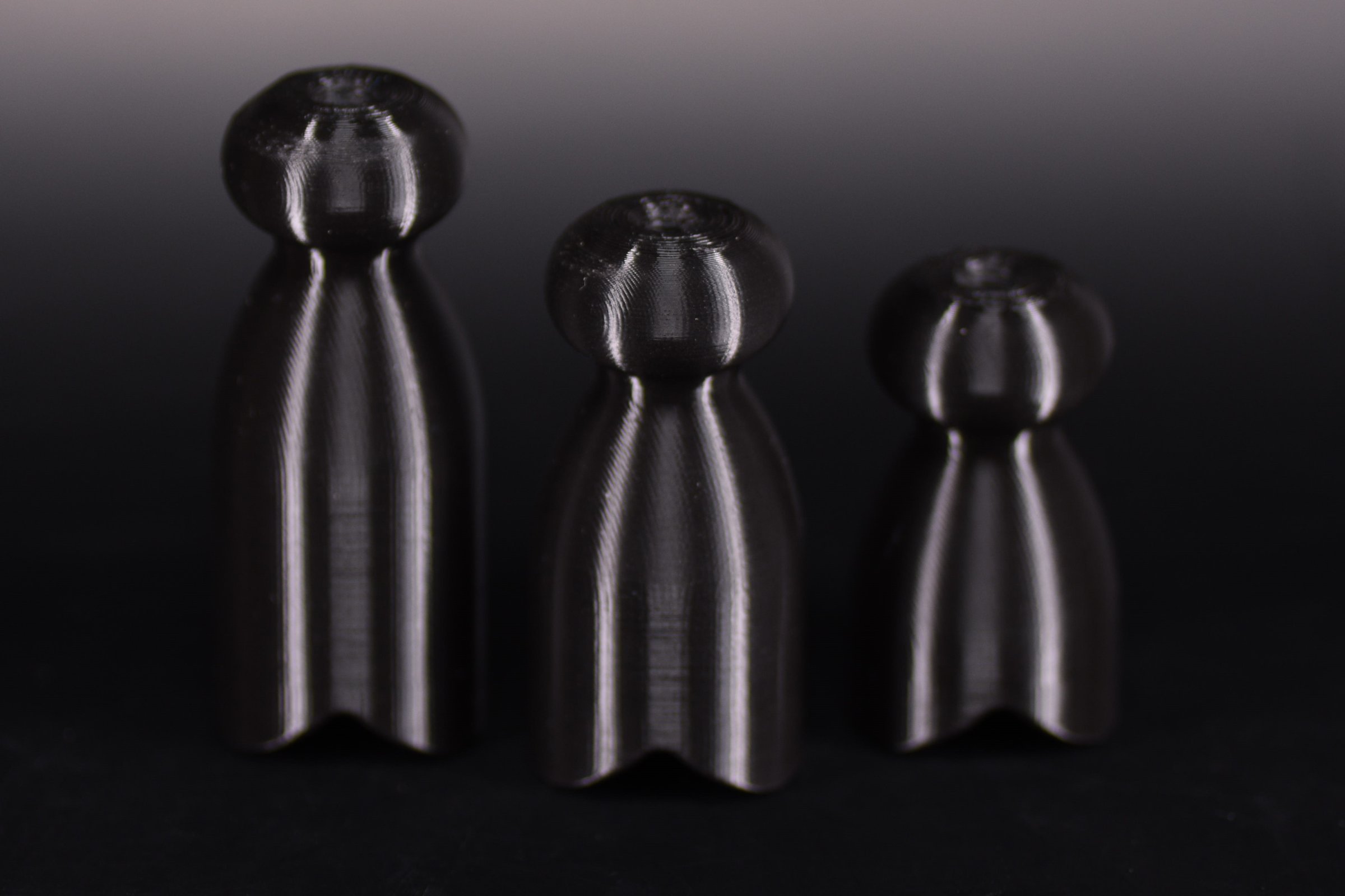 Three demo P-tainers of the same diameter in different lengths, side by side.