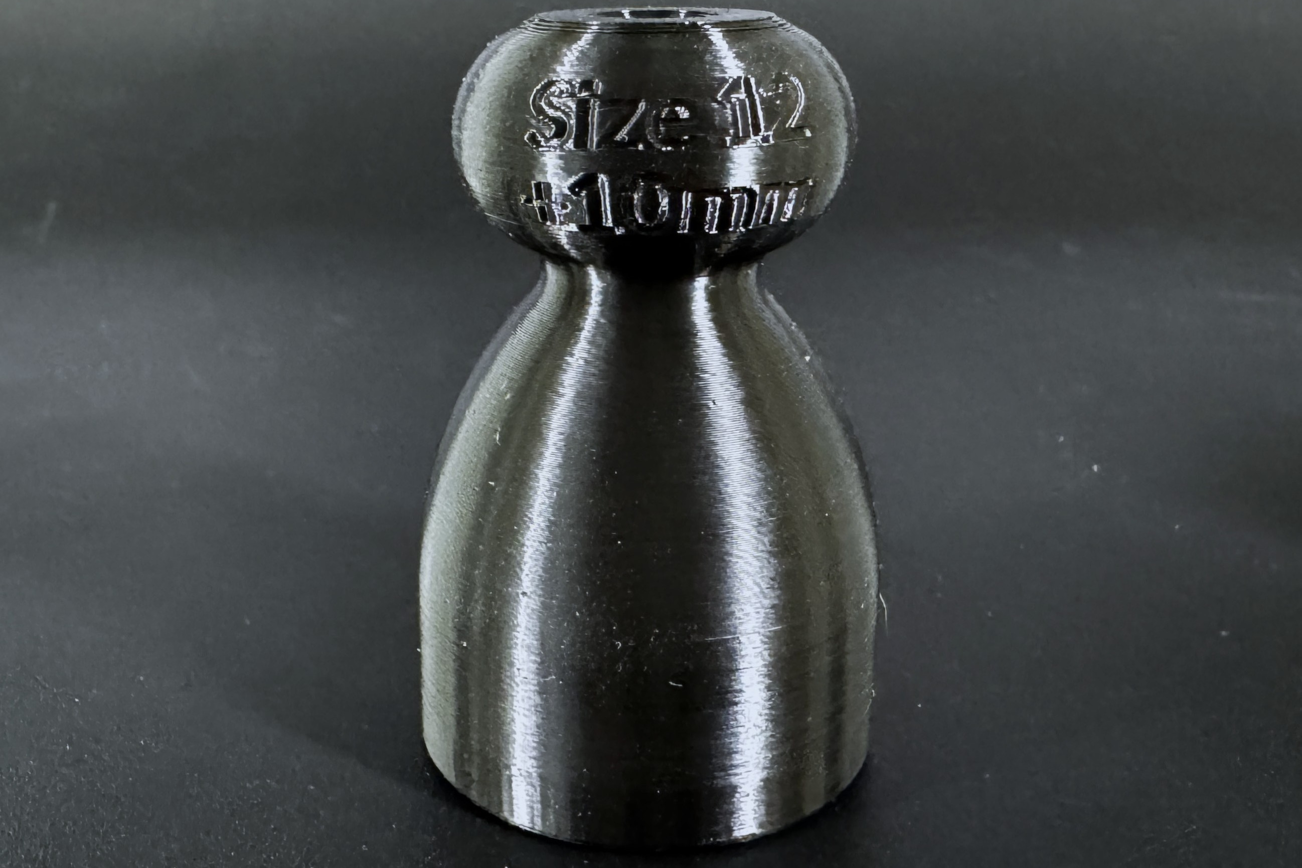 Close up of a demo P-tainer with its size and length printed on the knob end.