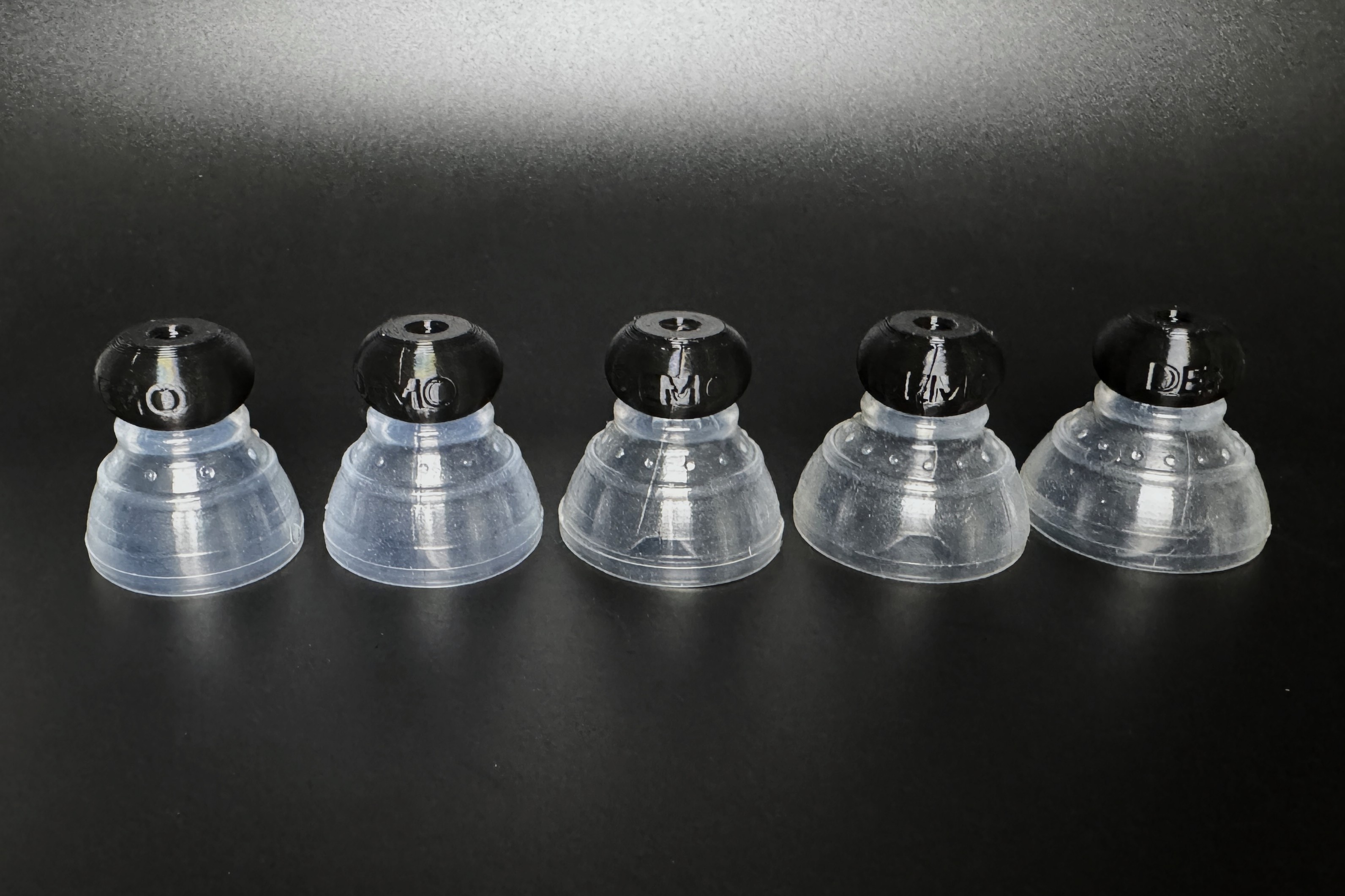 The five demo P-tainers with matching stiff silicone grippers fitted.