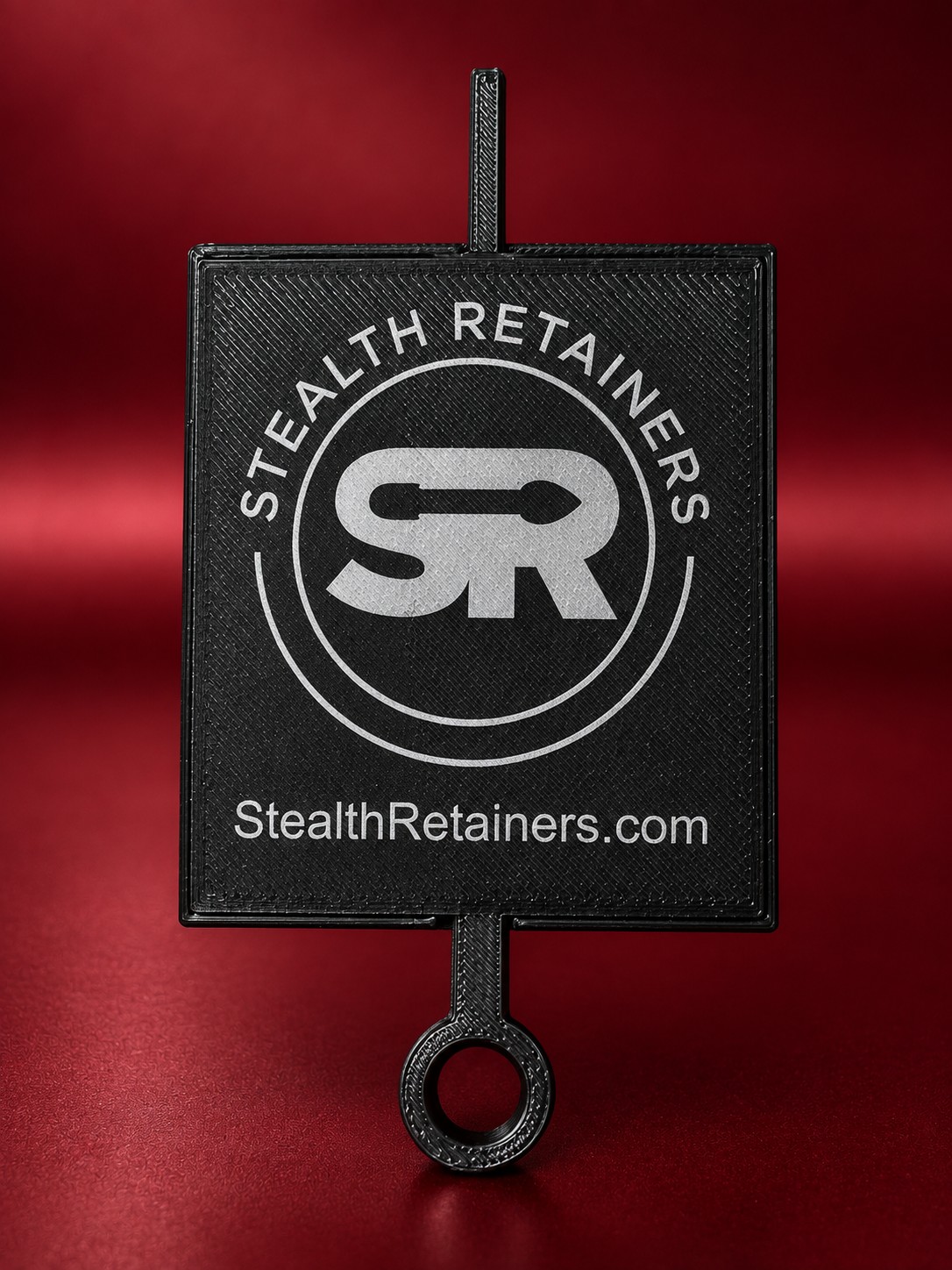 The back of the tension gauge, printed with the Stealth Retainers logo and StealthRetainers.com.