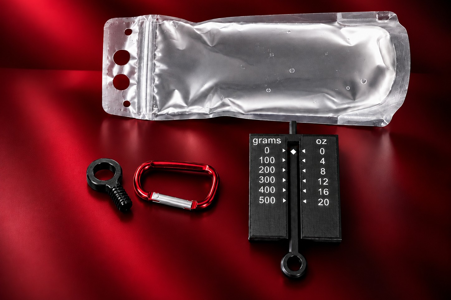 Water Weight Kit contents: collapsible water bottle, tension gauge marked in grams and ounces, red carabiner and the Plastic Tugging Ring.